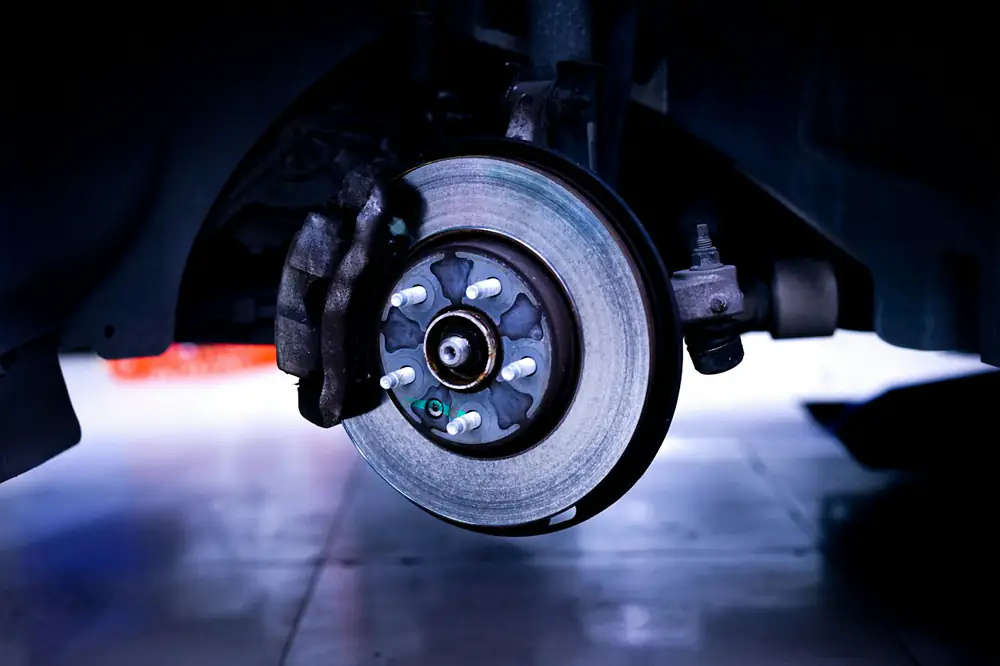 Brake rotor and caliper on a car up on a lift